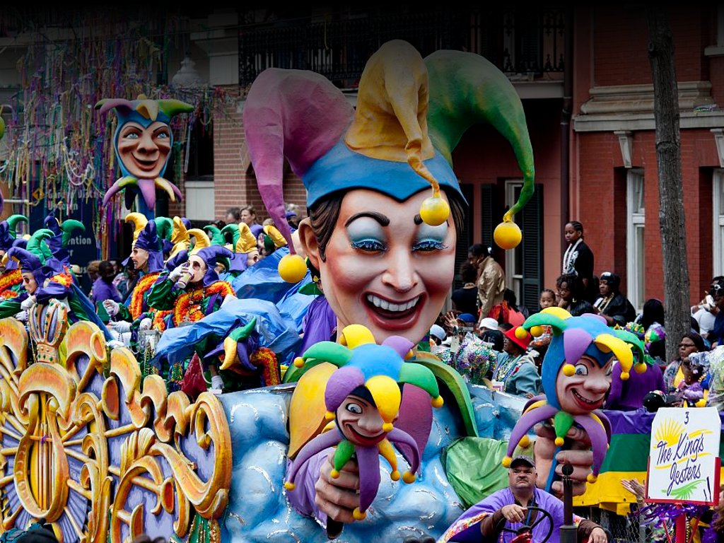 Photo of a colorful street parade with giant model heads
