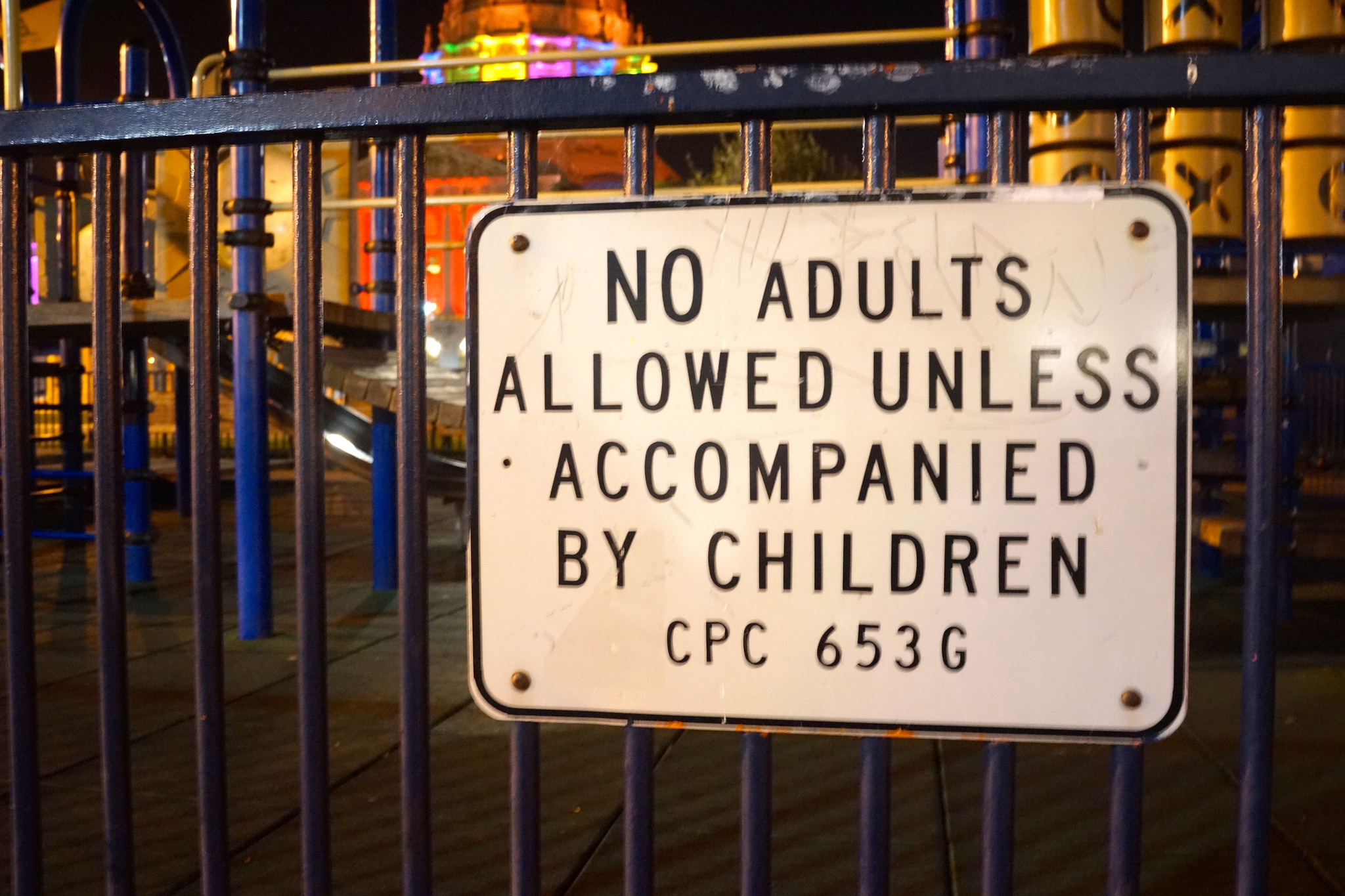 A sign next to a children's play area reading No Adults Allowed Unless Accompanied By Children