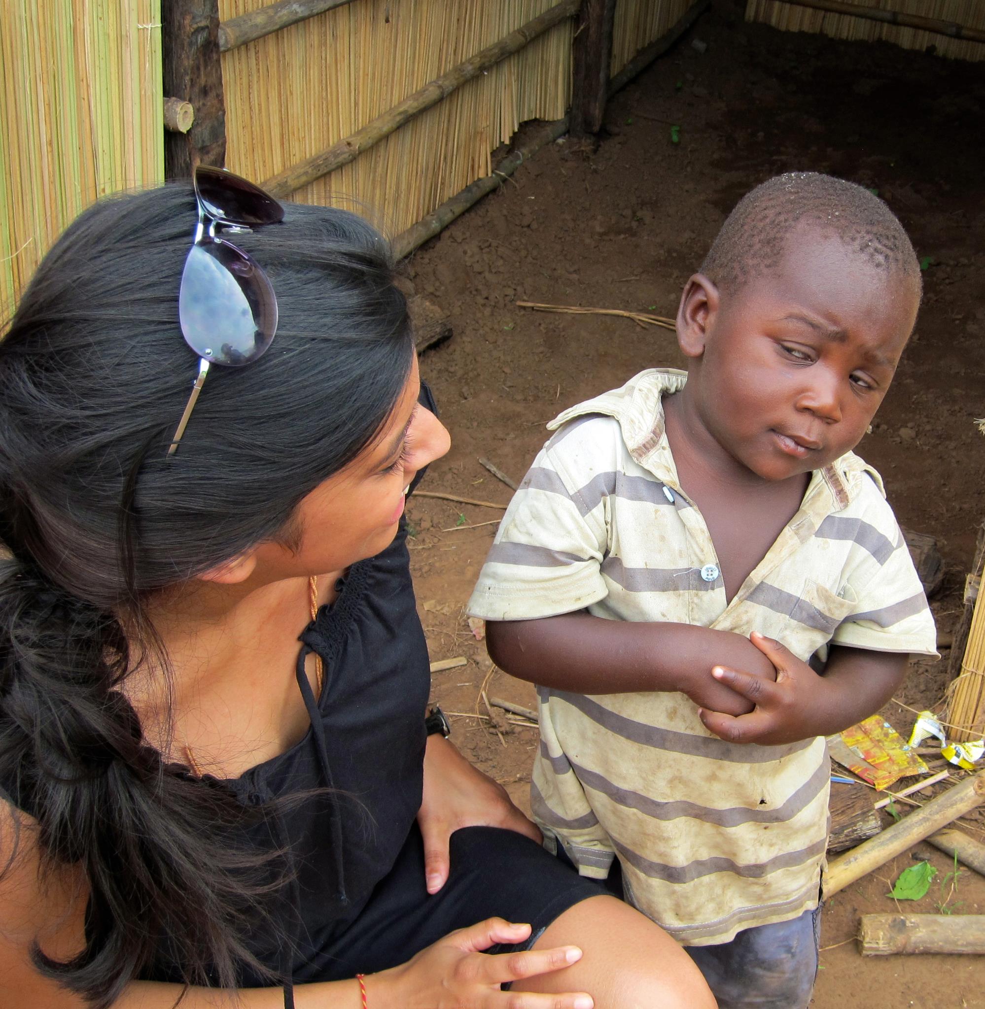 a young African boy looks very sceptically at what looks like an aid worker. The image has appeared countless times in social media and is known as Sceptical Third World Child