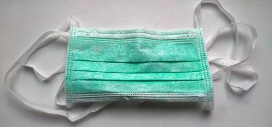 [photo of a green surgical mask with straps]