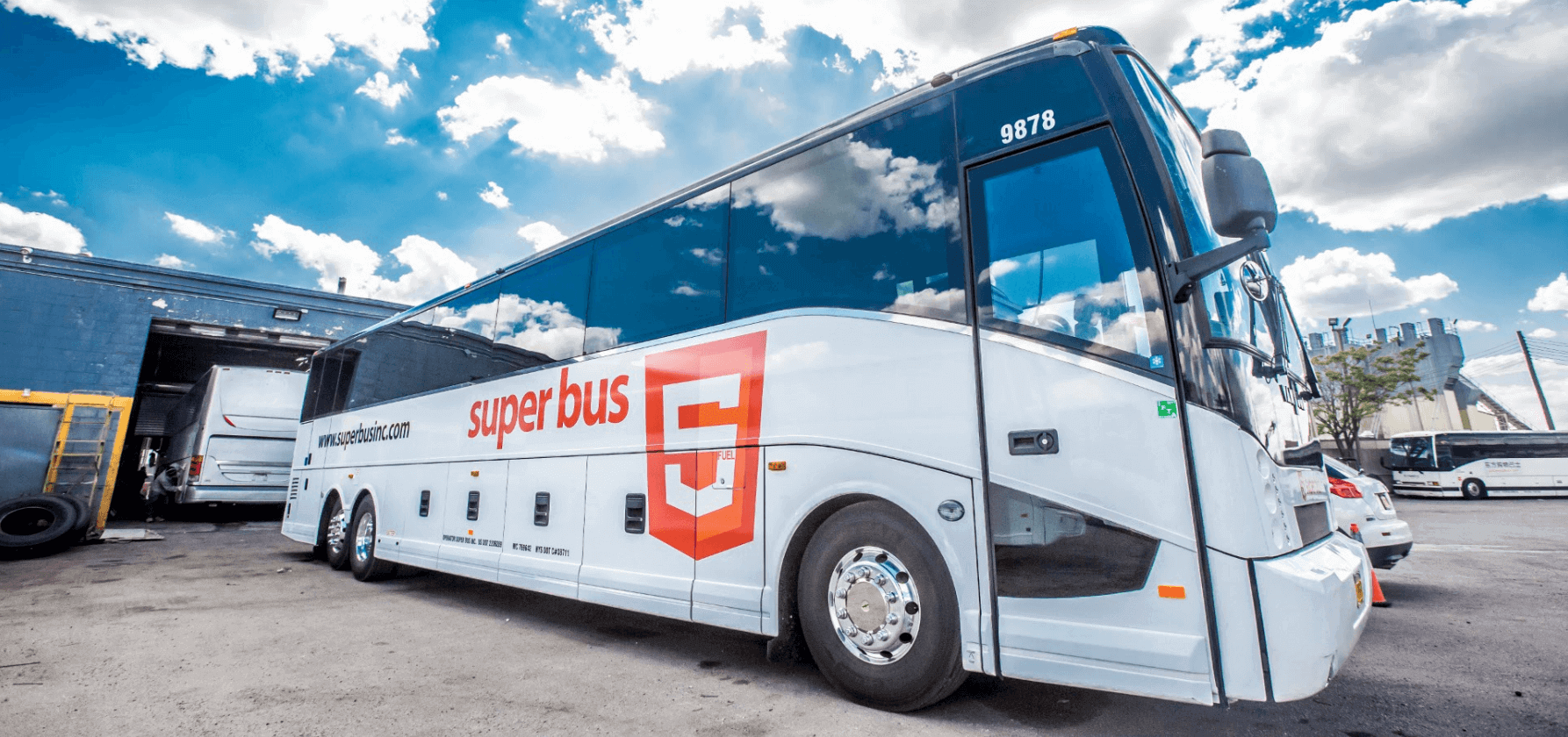 Picture of a Superbus inc. bus showing a variation of the HTML5 logo