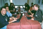 photo of people sitting at a table with laptops