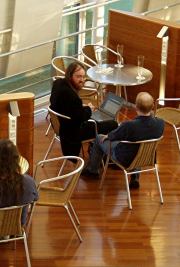 photo of two people sitting at a table talking