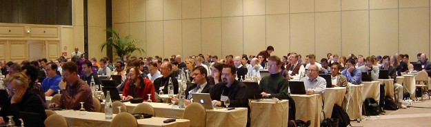 two to three hundred attendees seated in the meeting room