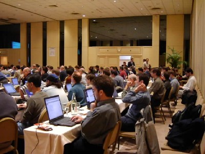 scene from the back left of the plenary room: people seated