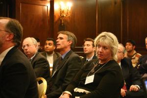 Audience seated and listening during press briefing