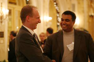 Two attendees greet each other