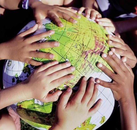 Children's hands on globe