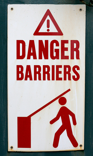 Danger Barriers sign (with person being hit on the head with lowering barrier