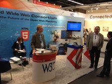 W3C staff prepare to greet visitors at the Mobile World Congress 2012 booth.