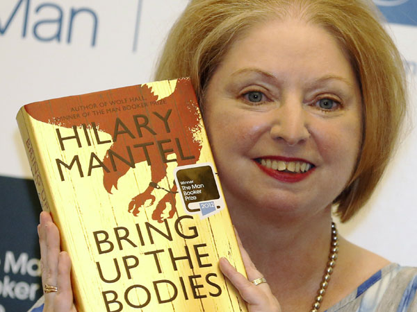Hilary Mantel holds a copy of her book Bring Up the Bodies