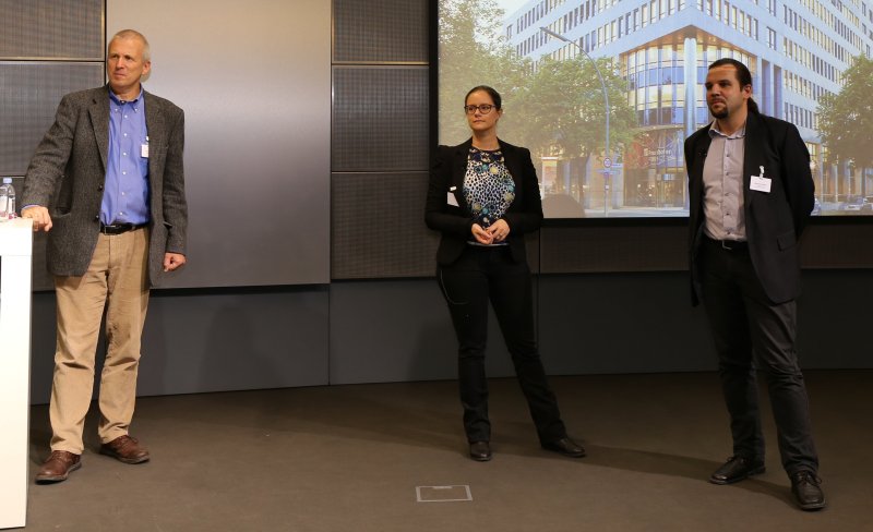 Three people on the podium at Fraunhofer FOKUS