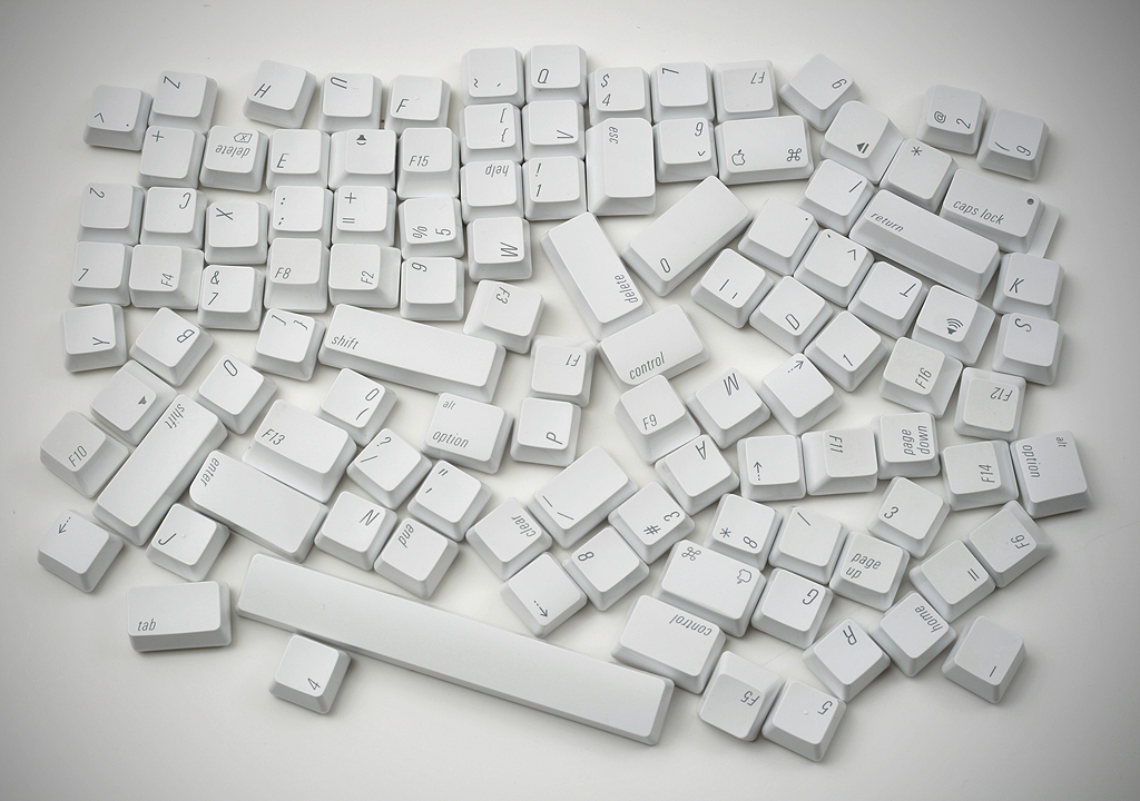 The keys of a keyboard disassembled and arranged haphazardly