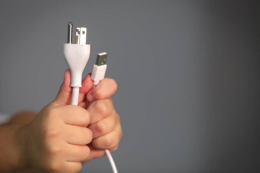 [illustration: photo of hands holding cables]
