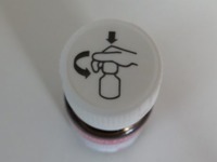 Push the cap down and turn it counter-clockwise (from right to left)