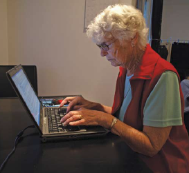 photo of old person typing on laptop