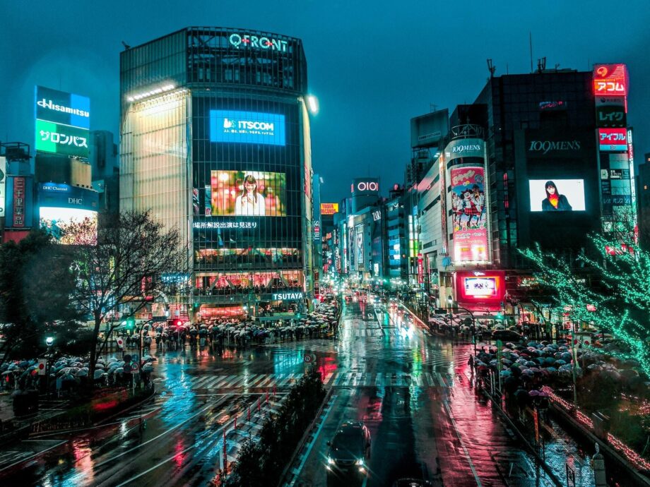 Shibuya crossing at night showing all kinds of advertising screens. Photo by Ling Tang on Unsplash