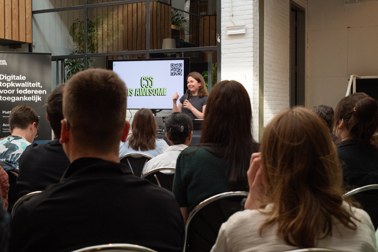 Cyd photographed from audience, she is talking and her slide says CSS is awesome and displays a QR code